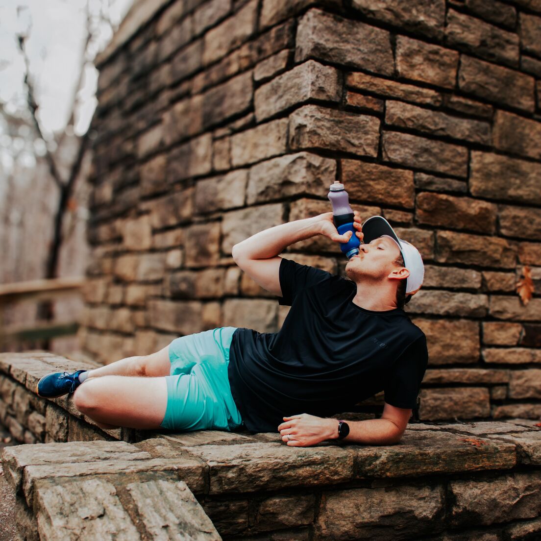 male drinking a swivel bottle in a funny pose
